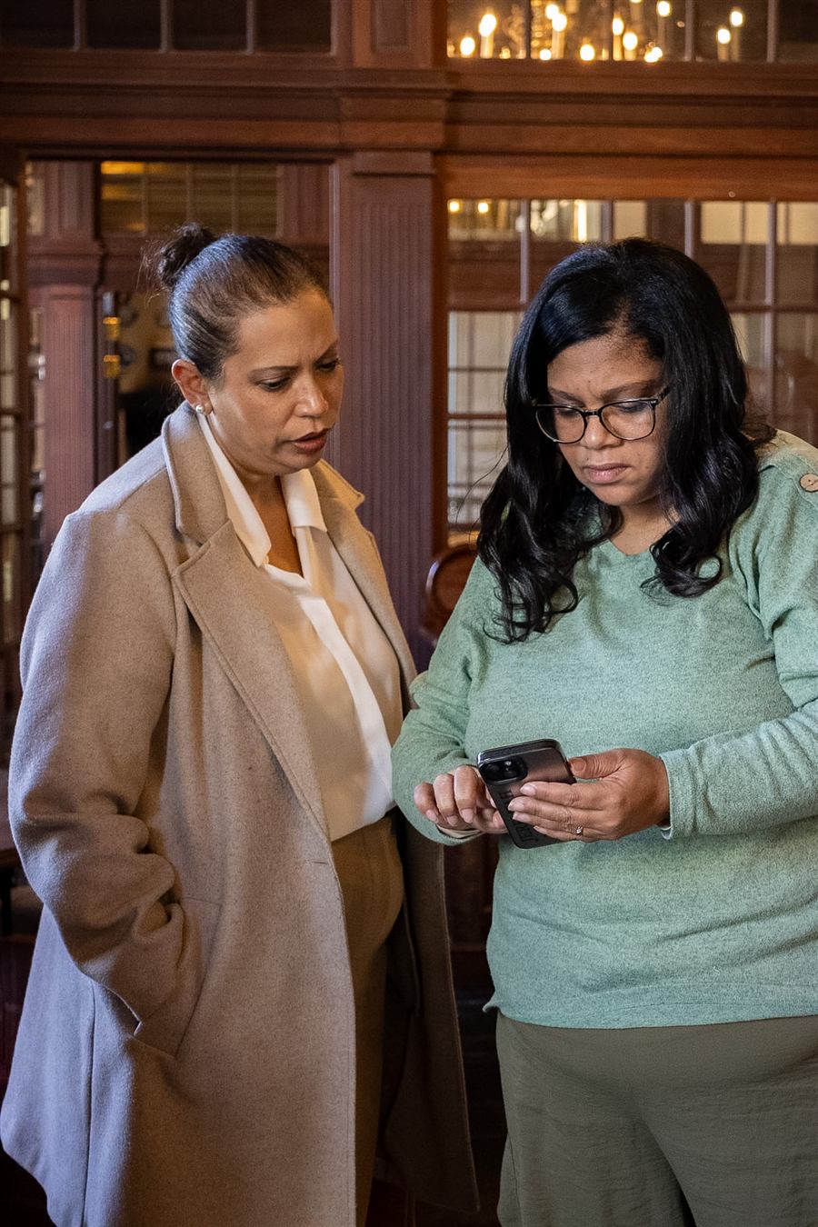 Etherecia and Leanie reading an application together